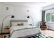 Spacious primary bedroom with hardwood floors, a large window, a seating area, and neutral decor at 1833 The Plz, Charlotte, NC 28205