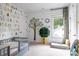 Stylized bedroom with gray daybed, wallpaper and window, creating a playful and inviting space at 1833 The Plz, Charlotte, NC 28205