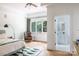 Well-lit bedroom with an ensuite bathroom, hardwood floors, and a comfortable seating area at 1833 The Plz, Charlotte, NC 28205