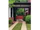 Charming brick home with a private driveway and gated entrance nestled among lush greenery at 1833 The Plz, Charlotte, NC 28205