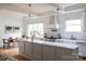 Bright kitchen featuring a large island, stainless steel appliances, and open layout to the dining area at 1833 The Plz, Charlotte, NC 28205