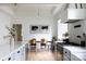 Well-lit kitchen with a central island, dining table, modern appliances, and stylish decor at 1833 The Plz, Charlotte, NC 28205
