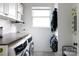 Bright laundry room with modern washer and dryer, ample counter space, and storage shelves at 1833 The Plz, Charlotte, NC 28205