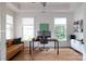 Bright home office with hardwood floors, natural light, modern desk, and a comfortable leather sofa at 1833 The Plz, Charlotte, NC 28205