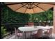 Backyard with a table and seating under a sunshade creates an inviting spot for outdoor meals and relaxation at 1833 The Plz, Charlotte, NC 28205