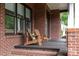 Relaxing front porch featuring chairs and brick flooring at 1833 The Plz, Charlotte, NC 28205