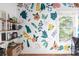 Charming room with a wall mural, open shelving, and natural light creates a cozy and inspiring atmosphere at 1833 The Plz, Charlotte, NC 28205