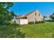 View of the backyard, showing the grassy area, white privacy fence and tidy landscaping at 1907 Sandal Brook Rd, Fort Mill, SC 29707