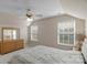 Bright bedroom features a vaulted ceiling, fan, and large windows for natural light at 1907 Sandal Brook Rd, Fort Mill, SC 29707