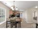 Charming dining area with modern lighting adjacent to the kitchen with natural light at 1907 Sandal Brook Rd, Fort Mill, SC 29707