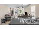Open-concept living room featuring hardwood floors and a ceiling fan, perfect for entertaining guests at 1907 Sandal Brook Rd, Fort Mill, SC 29707