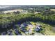 Aerial view of a neighborhood with trees, a playground, tennis courts, baseball fields, and other amenities nearby at 198 Wrangell Dr, Mooresville, NC 28117