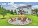 Large backyard featuring a fire pit with Adirondack chairs and a gazebo, ideal for outdoor entertaining at 198 Wrangell Dr, Mooresville, NC 28117