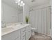 Bright bathroom featuring a double vanity, large mirror and a shower/tub combination with a stylish shower curtain at 198 Wrangell Dr, Mooresville, NC 28117
