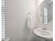 Bathroom featuring a pedestal sink, round mirror, and neutral wall color with a window at 198 Wrangell Dr, Mooresville, NC 28117