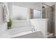 Bathroom features a soaking tub with chrome fixtures and a separate tiled shower at 198 Wrangell Dr, Mooresville, NC 28117