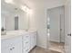 Bright bathroom with double vanity, white cabinets, large mirror, and modern fixtures at 198 Wrangell Dr, Mooresville, NC 28117