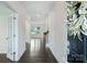 Bright foyer with hardwood floors, white trim, and an arched doorway leading to other rooms at 198 Wrangell Dr, Mooresville, NC 28117