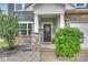 Inviting front porch with stone pillars, a decorative wreath on the door, and manicured bushes at 198 Wrangell Dr, Mooresville, NC 28117