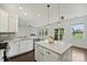 Bright kitchen featuring stainless steel appliances, white cabinets, and an island with a light countertop at 198 Wrangell Dr, Mooresville, NC 28117