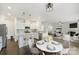 Modern kitchen with white cabinets, stainless steel appliances, and an island with bar seating at 198 Wrangell Dr, Mooresville, NC 28117