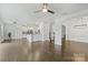 Open-concept living room with hardwood floors connecting to a kitchen and dining area at 198 Wrangell Dr, Mooresville, NC 28117