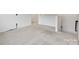 Upstairs loft area with neutral carpet, white walls, and natural light at 198 Wrangell Dr, Mooresville, NC 28117