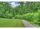 Sidewalk winding through green trees, perfect for leisurely walks and enjoying nature at 198 Wrangell Dr, Mooresville, NC 28117