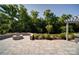 Relaxing backyard featuring a patio with a built-in fire pit and mature landscaping at 2035 Beacon Ave, Monroe, NC 28110