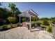Backyard featuring a pergola-covered hot tub on a stone patio, perfect for relaxation at 2035 Beacon Ave, Monroe, NC 28110