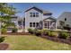 Spacious backyard featuring a covered patio, pergola, hot tub, and lush landscaping at 2035 Beacon Ave, Monroe, NC 28110