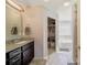 Well-lit bathroom featuring double vanity with granite counters, and a walk-in closet at 2035 Beacon Ave, Monroe, NC 28110