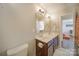 Bathroom with a double vanity, dark wood cabinets, and a large mirror at 2035 Beacon Ave, Monroe, NC 28110