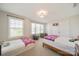 Bright bedroom with two beds, large windows, and a basketball hoop over the closet at 2035 Beacon Ave, Monroe, NC 28110