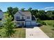 Two story blue home with a three car garage, lawn, and a well manicured front yard at 2035 Beacon Ave, Monroe, NC 28110