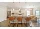 Modern kitchen design with pendant lights over an island and open dining area offers inviting and functional space at 2035 Beacon Ave, Monroe, NC 28110