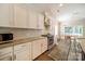 Charming kitchen features white cabinets, granite countertops, stainless steel appliances, and seamless transition to the dining area at 2035 Beacon Ave, Monroe, NC 28110