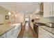 Bright kitchen with stainless appliances and granite countertops seamlessly transitions to the adjacent living spaces at 2035 Beacon Ave, Monroe, NC 28110