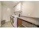 Laundry room with white cabinets, a counter, and front load washer and dryer set at 2035 Beacon Ave, Monroe, NC 28110