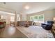 Bright living room featuring a large sectional sofa, area rug and lots of natural light at 2035 Beacon Ave, Monroe, NC 28110