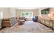 Spacious living room features a comfortable sectional, a console table and large windows at 2035 Beacon Ave, Monroe, NC 28110