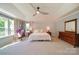 Serene main bedroom with a vaulted ceiling, a ceiling fan and large windows at 2035 Beacon Ave, Monroe, NC 28110