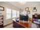 Bright office space with wood desk, multiple windows, and wall art creates a professional yet comfortable atmosphere at 2035 Beacon Ave, Monroe, NC 28110