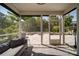 Comfortable screened-in porch offers seamless transition to outdoor patio with stone fire pit and seating area at 2035 Beacon Ave, Monroe, NC 28110