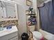 Bathroom featuring a tub with shower, vanity, toilet, and storage at 211 S Rowan Ave, Spencer, NC 28159