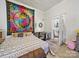 Bright bedroom with colorful tapestry, neutral decor, and a cozy crib at 211 S Rowan Ave, Spencer, NC 28159