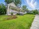 Exterior view of a well-kept lawn with a charming house and inviting front porch at 211 S Rowan Ave, Spencer, NC 28159