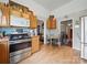Functional kitchen featuring stainless steel appliances and access to dining area at 211 S Rowan Ave, Spencer, NC 28159