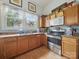 Functional kitchen space featuring wood cabinets, stainless appliances and ample counter space at 211 S Rowan Ave, Spencer, NC 28159
