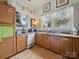 Bright kitchen area featuring stainless steel appliances and wood cabinets with ample storage at 211 S Rowan Ave, Spencer, NC 28159
